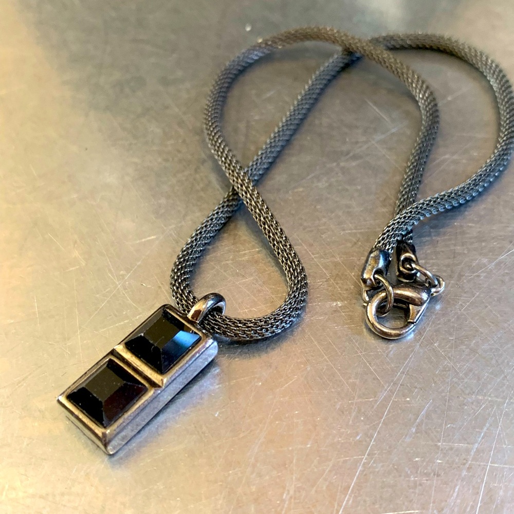 Black glass pendant with rope chain.